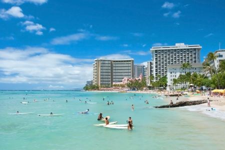 OAHU, HI - SEPTEMBER 19, 2011 - Tourist sunbathing and surfing on Waikiki beach September 19, 2011 in Oahu. Waikiki beach is beachfront neighborhood of Honolulu, best known for white sand and surfingのeditorial素材