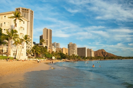 OAHU, HI - SEPTEMBER 22, 2011 - Tourist sunbathing and surfing on Waikiki beach September 22, 2011 in Oahu. Waikiki beach is beachfront neighborhood of Honolulu, best known for white sand and surfingのeditorial素材