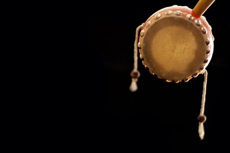 Small chinese drum over black background with a textspaceの写真素材
