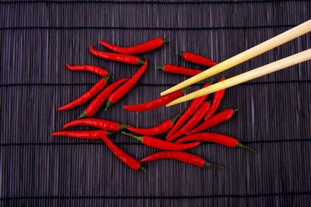 Hot chili pepper on bamboo matの写真素材