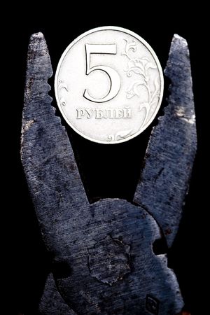 Compressing russian ruble with a pliersの写真素材