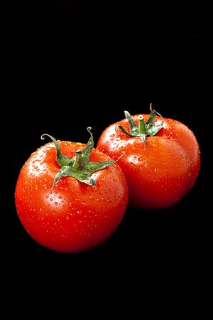 Two fresh tomatoes with waterdropsの写真素材