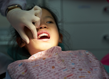 dentist hand open mouth exam kidの写真素材