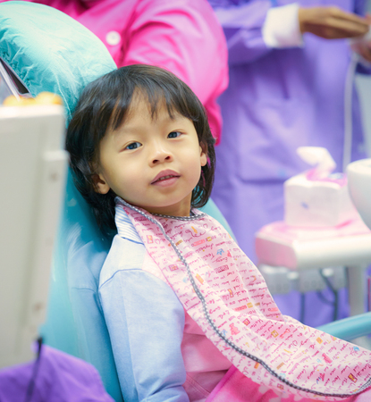 cute boy chlid sit on dental chair wait for dentist exam without nervousの写真素材