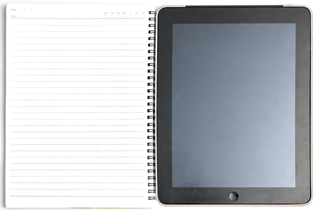 Tablet computer and ring paper note book on whitebackground in useful of technology ,change world of drawing and writing for reccord details in education ,business,shoppingの写真素材