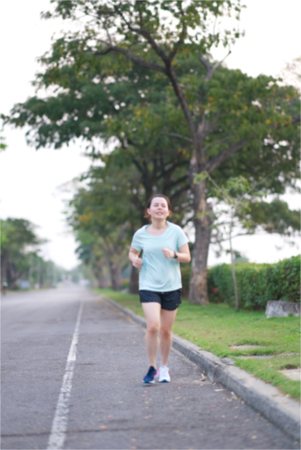 Blur photo of Asian runner is running along traffic street way in the morningの写真素材