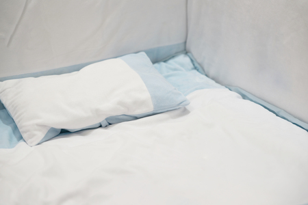 Baby pillow bed and bumper in white and blue toneの写真素材