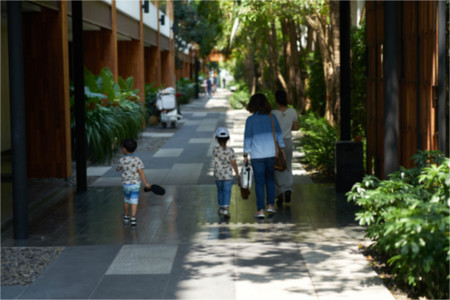 Asian traveler family in hotel walkway with receptionistの写真素材