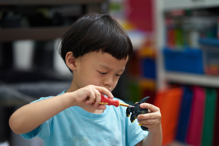 Boy focus on fix toyの写真素材