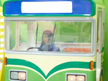 young girl plays driving busの写真素材