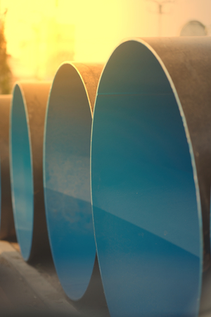 blue construction big pipe before install with sun flareの写真素材