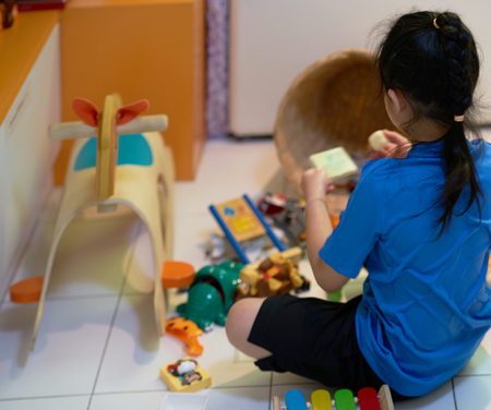 kid is playing toy in living room corner for alone conceptの写真素材