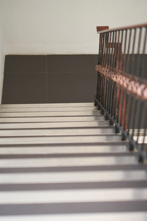Down view of stairs and vintage grating handrailの写真素材