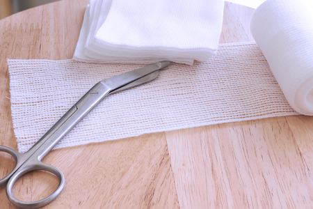 Dressing or clean wound tools includes Roll gauze,pile of gauzes and gauze roll cutter or scissorsの写真素材