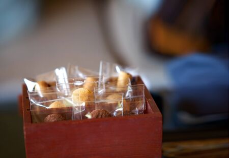 Cookies snack sealed in plastic bag in wooden box for reception at welcome counter