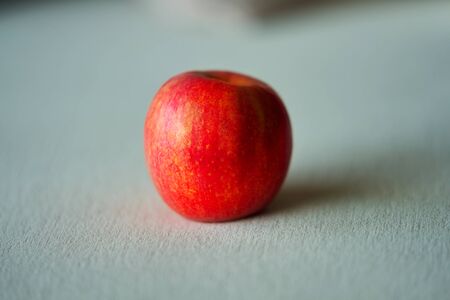Red apple on silky floor with shadeの写真素材