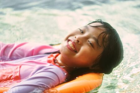 Girl portratit in swimming suit with happy face expression in summer vacation conceptの写真素材