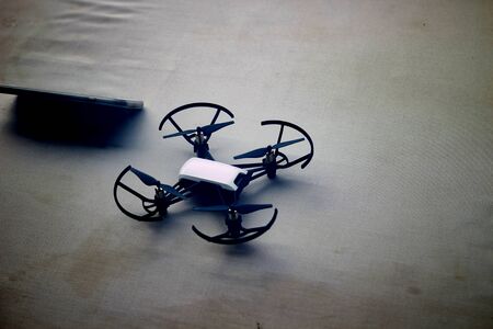 radio controlled drone with smartphone on bed in vacation air photography concept