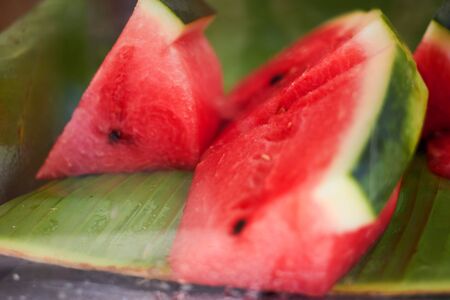 red sliced watermelon with seeds in natural banana leaf serve,closed up