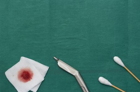 Gauze, scissors and swab cotton bus sticks on green medical surgical dressの写真素材