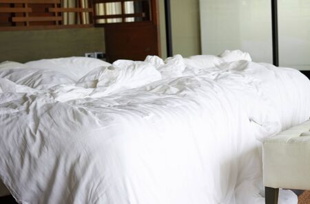 Mess bed sheet in the room of hotelの写真素材