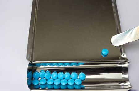 blue coated tablet on tray in drugstore business and healthcare concept with copy spaceの写真素材