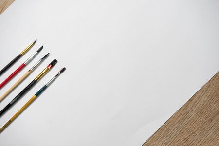 Paper of art work and color brushes,side viewの写真素材