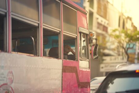 Public bus on street city view with sun flare in community service transportationの写真素材