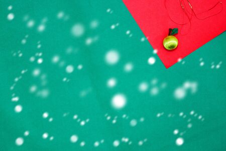 yellow fruit on red and green background with copy space for new year and christmas time with snow fallの写真素材