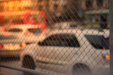 Metal net  fence view on sun light traffic jam backgroundの写真素材