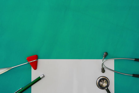 Mock up and hammer jerk ,stethoscope and flash light on green surgery background in ENT examination medical healthcare concept with copy spaceの写真素材