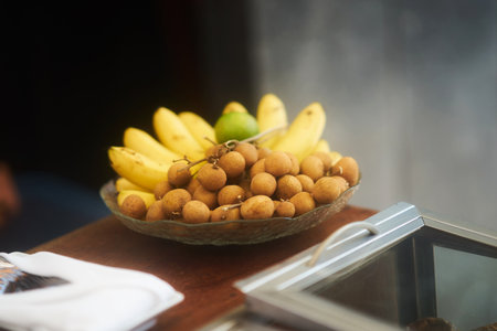 Longan ,banana and orange on glass bowl on table for serving