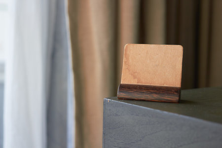 mock up vintage brown paper sign or symbol label card holder on corner of tableの写真素材