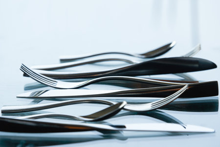 knife ,fork and stainless spoons in dramatic light with closed up