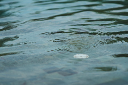 surface mosaic of water swirl on swimming pool on blur drainage backgroundの写真素材