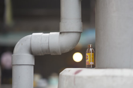small bottle garbage on plumbing pipe