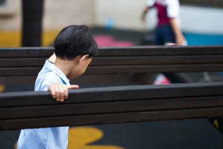kid in uniform play in playground with copy spaceの写真素材
