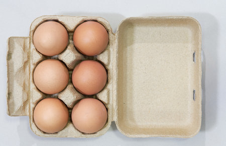 eggs in pack box on white background with copy space