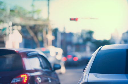 cars wait for traffic light on blur cityscape background with copy spaceの写真素材