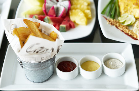 thick cut potato chip or french fried on plate with tomato ketchup,salad dip ,mayonaise dipの写真素材