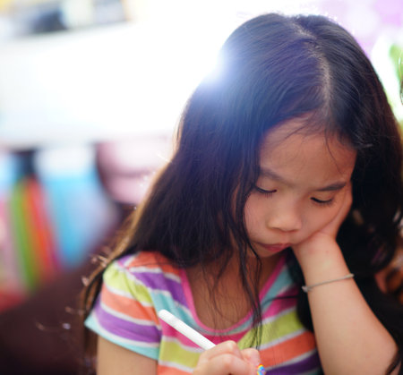 Asian girl focus on writing penの写真素材