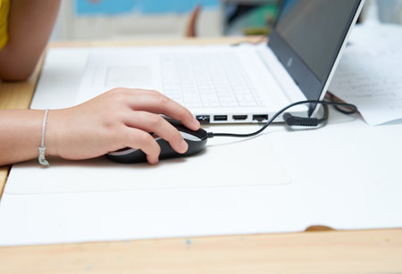 closed up of mouse with kid hand and notebookの写真素材