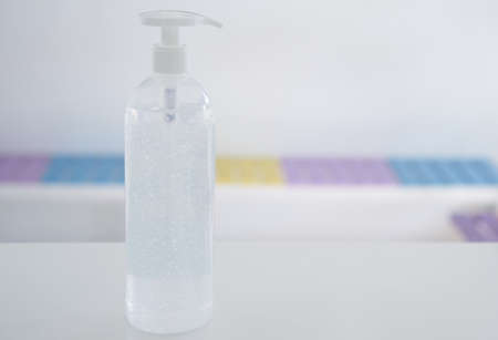 pumping alcohol gel bottle on recepteion counter with copy spaceの写真素材