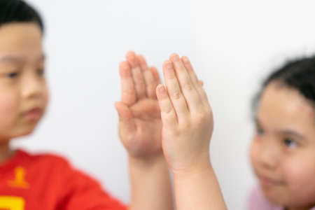 kids hands high five on white backgroundの写真素材