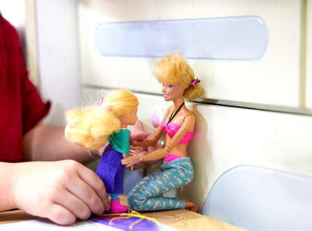 Bangkok, Thailand,Mar 5,2021-back view hair bun of Barbie doll in diy costume on surf board with child daughterのeditorial素材