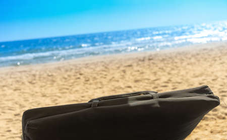 empty beach chair at sand and blue sea in tropical sceneの写真素材