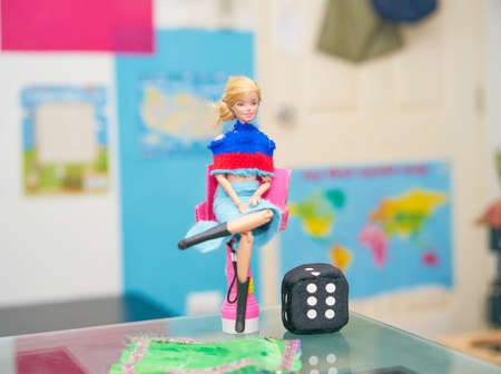 Bangkok, Thailand,mar 12 ,2021-Barbie doll with accessories on blur background  sit on chair