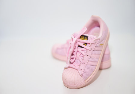 Bangkok,Thailand,July 2,2021-adidas pink sneakers shoes with shoelace side view on floor soft focus with copy spaceのeditorial素材
