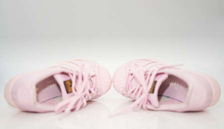 Bangkok,Thailand,July 2,2021-adidas pink sneakers shoes with shoelace side view on floor soft focus with copy spaceのeditorial素材