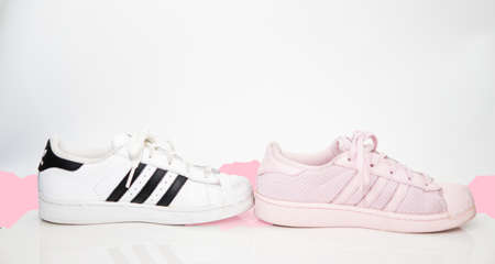bangkok,Thailand,July 2,2021-original adidas  sneakers shoes with shoelace half white and pink on white floor side view soft focus with copy spaceのeditorial素材